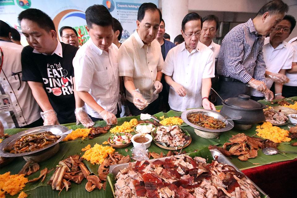 At a press conference in Quezon City on Monday, September 9, 2019, Department of Agriculture employees join Health Secretary Francisco Duque III and DA Secretary William Dar in a boodle fight dubbed 'Pork Challenge' to assure the public that it is safe to eat pork following reports on the entry of African Swine Fever in the Philippines. GMA News
