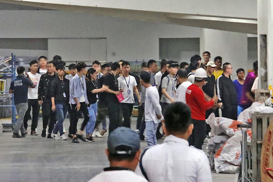 About 500 Chinese nationals working at a Philippine Offshore Gaming Operation walk out of their offices at a building in Libis, Quezon City during a raid by Bureau of Internal Revenue agents on Wednesday, September 25, 2019. The BIR's Task Force POGO enforced the closure and shutdown of operations of the establishment in compliance with a Department of Finance directive. GMA News