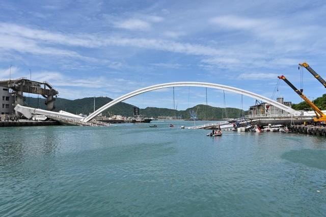 The bridge collapse injured at least 14 people as it smashed down onto fishing vessels moored underneath and sent a petrol tanker plummeting into the water. Sam Yeh/AFP