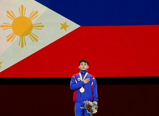 Carlos Yulo takes the gold in the men's floor event at the 2019 World Artistic Gymnastics Championships at the Hanns-Martin-Schleyer-Halle, Stuttgart, Germany, October 12, 2019. REUTERS/Wolfgang Rattay