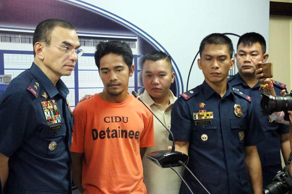 At a press conference in Camp Crame on Friday, October 4, 2019, NCRPO chief Major General Guillermo Eleazar (left) presents Agimar Abi Ahaja alias Ibrahim Lambug Mullo, 26, a suspected Abu Sayyaf sub-leader who was recently arrested in Brgy. Batasan Hills, Quezon City. Seized from the suspect is an unlicensed .45 cal pistol and a grenade. NCRPO photo 