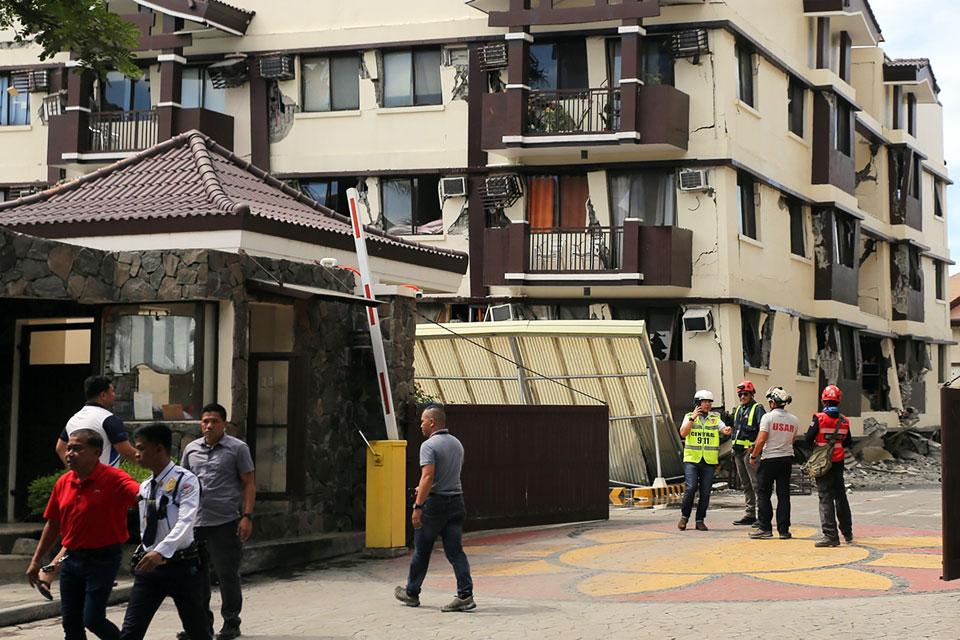 An emergency rescue team inspects a damaged condominium complex after a 6.5 magnitude earthquake hit Davao City on Thursday, October 31, 2019. AFP/Manman Dejeto 