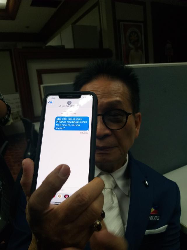 Presidential spokesperson holds up his phone showing a message that he said he sent to Vice President Leni Robredo. Photo: Virgil Lopez