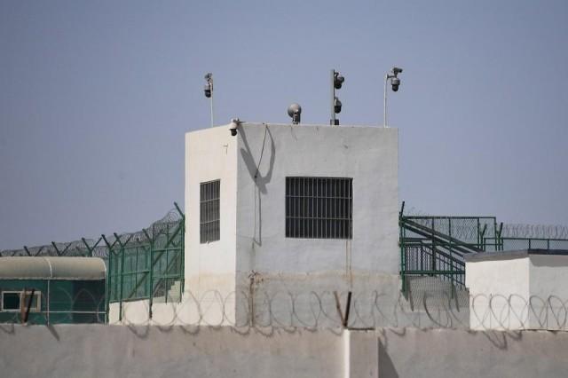 This file photo taken on May 31, 2019 shows the outer wall of a complex which includes what is believed to be a re-education camp where mostly Muslim ethnic minorities are detained, on the outskirts of Hotan, in China's northwestern Xinjiang region. Greg Baker/AFP