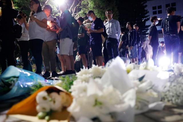 People pay tribute with flowers to Chow Tsz-lok, 22, a university student who fell during protests at the weekend and died early on Friday morning, at the Hong Kong University of Science and Technology, in Hong Kong, China November 8, 2019. REUTERS/Tyrone Siu