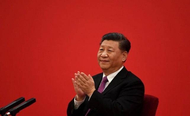 China&acirc;s President Xi Jinping claps as he listens to Russia's President Vladimir Putin speak via a video link, at the Great Hall of the People in Beijing on December 2, 2019. Noel Celis/Pool/AFP