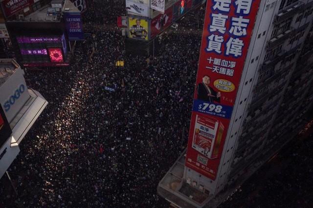 People crowd roads in the Causeway Bay area as they take part in a pro-democracy rally from Victoria Park to Chater Road in Hong Kong on December 8, 2019 that they have billed as a "last chance" for the city's pro-Beijing leaders in a major test for the six-month-old movement. Alastair Pike/AFP