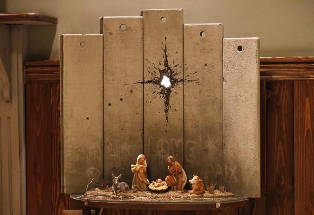 A new Christmas-themed artwork dubbed the "Scar of Bethlehem" by secretive British artist Banksy is displayed at his Walled-Off Hotel in Bethlehem in the occupied West Bank on December 20, 2019. Ahmad Gharabli/AFP