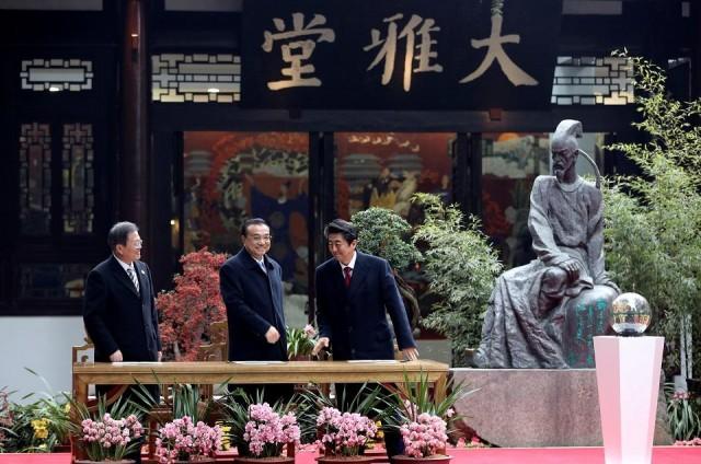 Chinese Premier Li Keqiang, South Korean President Moon Jae-in and Japanese Prime Minister Shinzo Abe attend an event marking the 20th anniversary of the China-Japan-ROK cooperation on the sidelines of the 8th trilateral leaders' meeting in Chengdu, Sichuan province, China December 24, 2019. China Daily via REUTERS