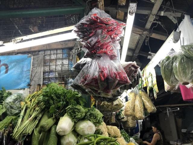 A vegetable vendor sells siling labuyo at Kamuning Market. Photo taken December 19, 2019. Tina Panganiban-Perez