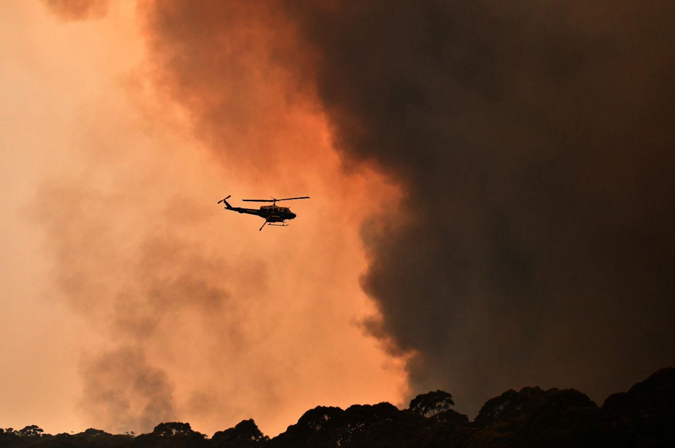 A helicopter is seen during a bushfire near Bilpin, 90 km north west of Sydney, Australia, December 19, 2019. AAP Image/Mick Tsikas/via REUTERS 