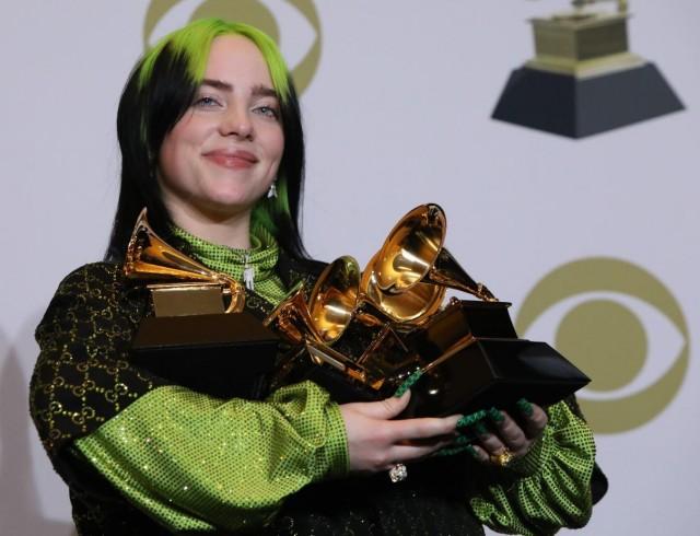 Billie Eilish poses backstage with her awards to include Song of the Year for "Bad Guy" , Best New Artist, and Album of the Year for "When We All Fall Asleep, Where Do We Go?". REUTERS/Monica Almeida