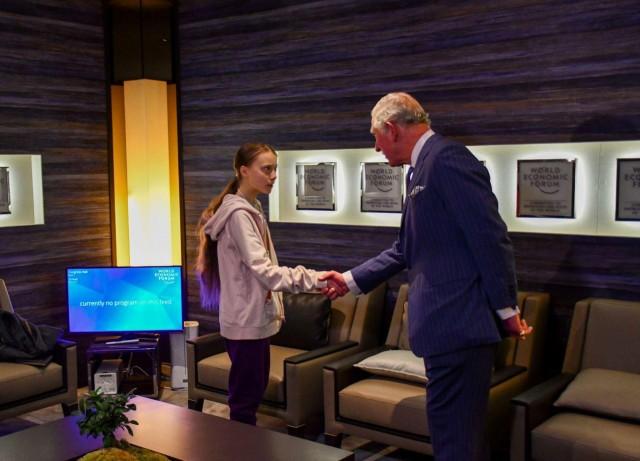 Britian's Prince Charles shakes hands with Swedish climate change activist Greta Thunberg at the 50th World Economic Forum (WEF) annual meeting in Davos, Switzerland January 22, 2020. Clarence House/Handout via REUTERS