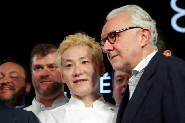 Newly awarded three-star Michelin chef Kei Kobayashi of Kei restaurant poses next to chef Alain Ducasse on stage during the Michelin Guide 2020 award ceremony in Paris, France, January 27, 2020. REUTERS/Charles Platiau