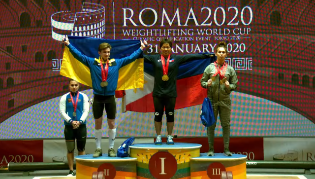 Hidilyn Diaz posts for photos on the podium after bagging three gold medals in the Weightlifting World Cup in Rome, Italy.