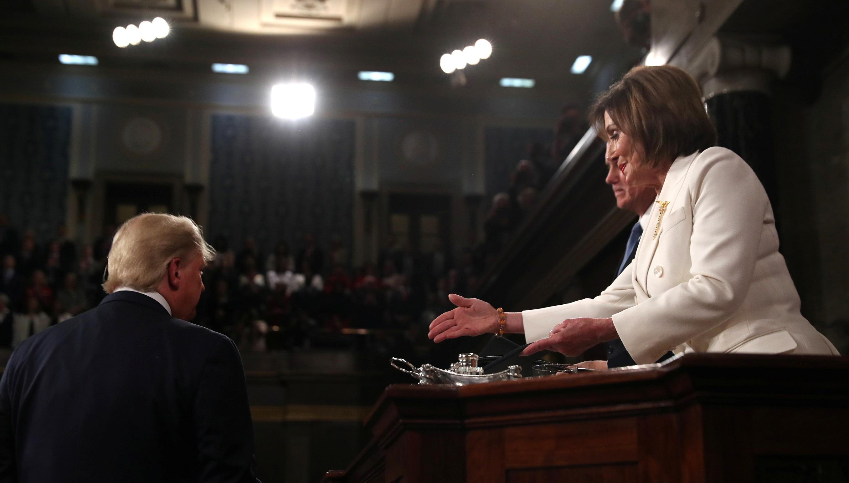 President Donald Trump turns away as Speaker of the House Nancy Pelosi reaches out to shake his hand as he arrives to deliver his State of the Union address to a joint session of the U.S. Congress in the House Chamber of the U.S. Capitol in Washington, U.S. February 4, 2020. REUTERS/Leah Millis/POOL TPX IMAGES OF THE DAY