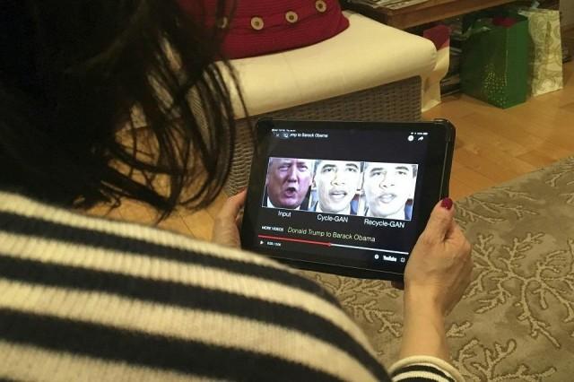 A woman in Washington, DC, views a manipulated video on January 24, 2019, that changes what is said by President Donald Trump and former president Barack Obama, illustrating how “deepfake†technology can deceive viewers. Rob Lever/AFP