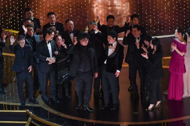 "Parasite" producers Kwak Sin-ae (L) and Bong Joon-ho (C) accept the award for Best Picture for "Parasite" during the 92nd Oscars at the Dolby Theatre in Hollywood, California on February 9, 2020. Mark RALSTON / AFP
