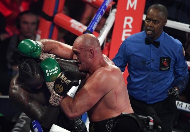 British boxer Tyson Fury (C) lands a punch before defeating US boxer Deontay Wilder in the seventh round during their World Boxing Council (WBC) Heavyweight Championship Title boxing match at the MGM Grand Garden Arena in Las Vegas on February 22, 2020. Mark RALSTON / AFP