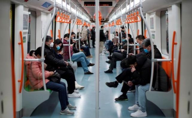 People wearing face masks ride a subway in the morning after the extended Lunar New Year holiday caused by the novel coronavirus outbreak, in Shanghai, China February 10, 2020. REUTERS/Aly Song