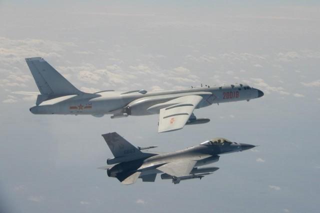 An H-6 bomber of Chinese PLA Air Force flies near a Taiwan F-16 in this February 10, 2020 handout photo provided by Taiwan Ministry of National Defense. In a statement, the ministry said Chinese J-11 fighters and H-6 bombers flew into the Bashi Channel to the south of Taiwan, then out into the Pacific before heading back to base via the Miyako Strait. Taiwan Ministry of National Defense/Handout via REUTERS