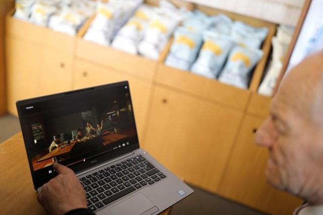 Owner Cesar Bonilla, 87, speaks as he shows can of Bonilla a La Vista potato chips in a clip from the "Parasite" film by director Bong Joon-ho during an interview inside his factory in Arteixo, near Coruna, Spain February 17, 2020. REUTERS