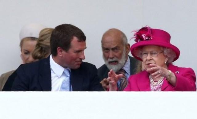 In this file photo taken on June 12, 2016, Britain's Queen Elizabeth II (R) speaks with Peter Phillips as she attends the Patron's Lunch, a special street party outside Buckingham Palace in London. JUSTIN TALLIS / AFP