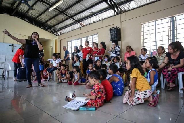 In this photo taken on February 1, 2020, participants who have lost family members due to alleged extrajudicial killings attend a session as part of the Project Support Orphans and Widows (SOW) rehabilitation program in Payatas, Quezon City. Jam Sta. Rosa/AFP