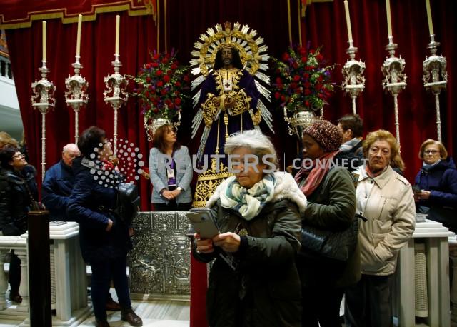 A worshiper stands next to the icon of Jesus de Medinaceli after religious authorities asked to abstain from kissing its feet amidst coronavirus fears at the Basilica of Jesus de Medinaceli in central Madrid, Spain, March 6, 2020. REUTERS/Javier Barbancho
