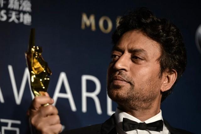 In this file photo taken on March 27, 2014 Best Actor winner Irrfan Khan poses with his trophy during the Asian Film Awards in Macau. Acclaimed Indian actor Irrfan Khan, whose international movie career included hits like "Slumdog Millionaire", "Life of Pi" and "The Amazing Spider-Man", has died aged just 53, his publicist said on April 29, 2020. Philippe LOPEZ / AFP