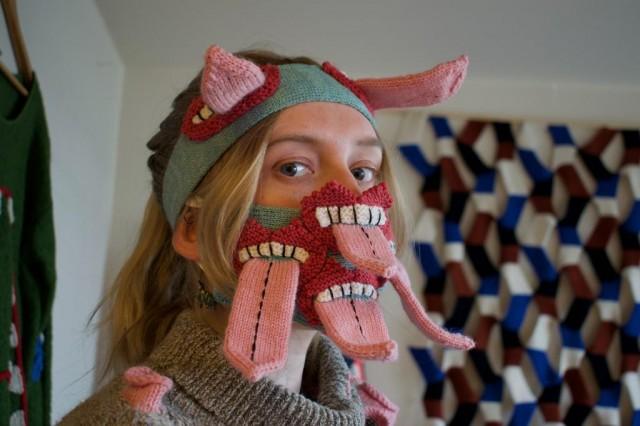 Fashion designer Yr Johannsdottir poses for a photo wearing one of her masks at her studio in Reykjavik, Iceland on May 11, 2020. Throughout the pandemic the effectiveness of masks have been under debate, but Icelandic designer Yr Johannsdottir's knitted masks aren't for protection but tries to encourage social distancing, by letting wearers hide behind scary tongues or fangs. JEREMIE RICHARD / AFP