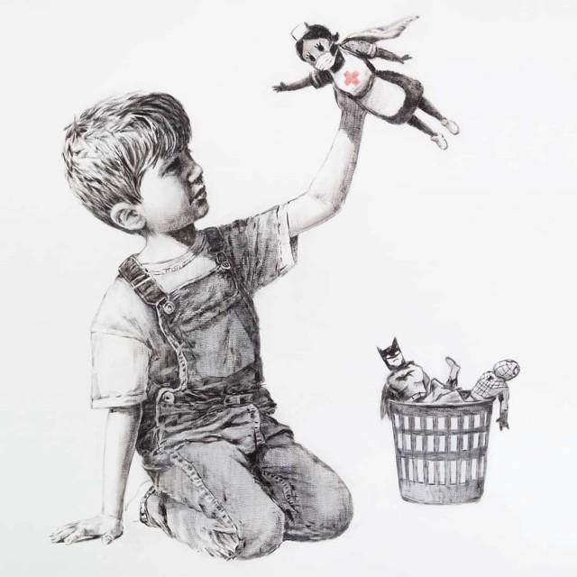 A picture shows a drawing created by the street artist Banksy called "Game Changer" as an appreciation for the NHS and is on display at Southampton General Hospital, in Southampton, Britain May 6, 2020 in this picture obtained from social media. It shows a boy dressed in dungarees playing with a nurse superhero toy with figures of Batman and Spiderman discarded in a basket on the floor. @BANKSY INSTRAGRAM/via REUTERS