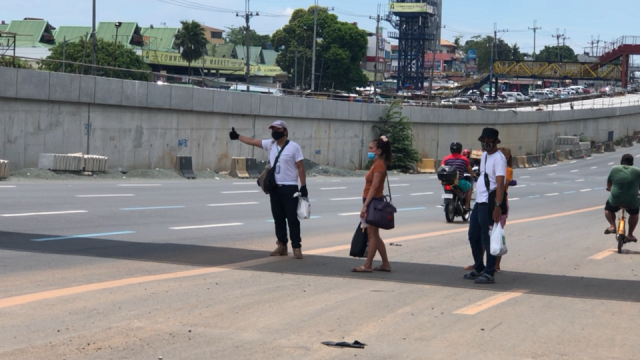 Stay-in security guard Jason Ignacio tries to thumb a ride on Commonwealth Avenue in Quezon City on Wednesday, May 27, 2020. He&acirc;s trying to get home to North Caloocan and has already hitched rides from five different motorists to get to Commonwealth from Shaw Boulevard. Tina Panganiban-Perez