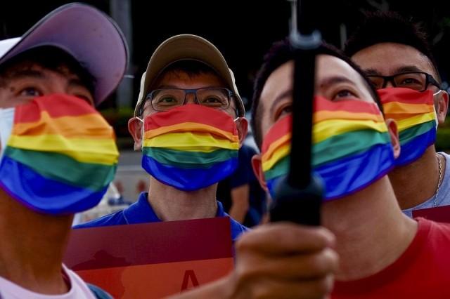 LGBT rights activists take selfies during a gay pride parade outside the Chiang Kai-shek Memorial Hall in Taipei on June 28, 2020. Sam Yeh/AFP