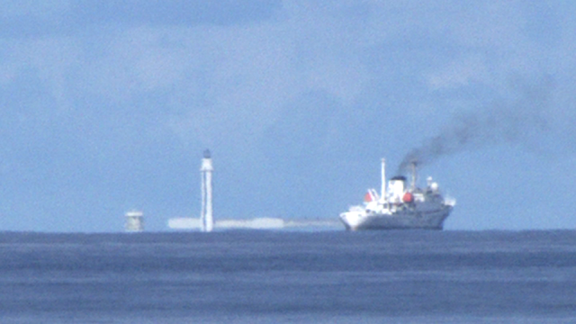 Video screen grab of the Chinese lighthouse at Subi Reef. A Chinese Coast Guard ship is in the foreground.