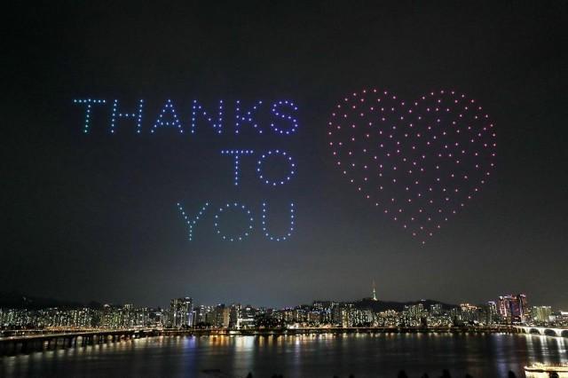 Drones fly over the Han river showing messages to support the country as the fight against the spread of COVID-19 continues in Seoul, South Korea, July 4, 2020. Yonhap via REUTERS