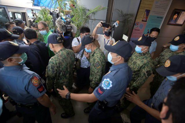 The 9 Jolo cops were escorted out of the NBI HQ after the preliminary investigation. The will be brought back to Camp Carme.