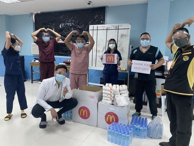 Medical workers from Caloocan Medical Center pose for a photo with the McDonald's hand gesture