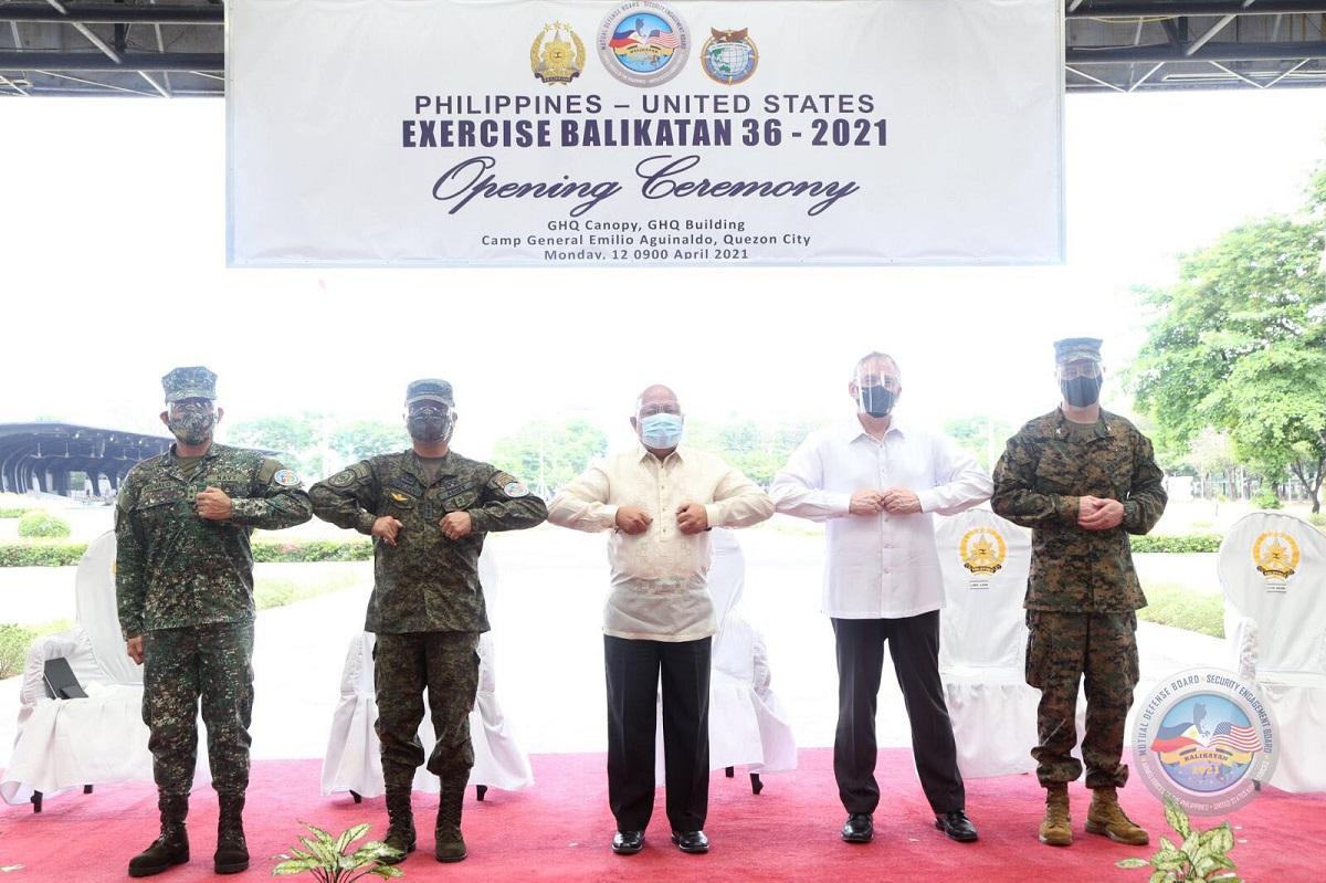 From left: Major General Edgard Arevalo, Lieutenant General Cirilito Sobejana, Defense Undersecretary Cesar B. Yano, US ChargÃ© d'Affaires John Law and Colonel Aaron Brunk modify the traditional shoulder-to-shoulder pose in observance of the COVID-19 mitigation guidelines at the 36th Balikatan Exercise Opening Ceremony at Camp Aguinaldo, Quezon City on Monday, April 21, 2021. Photo: AFP