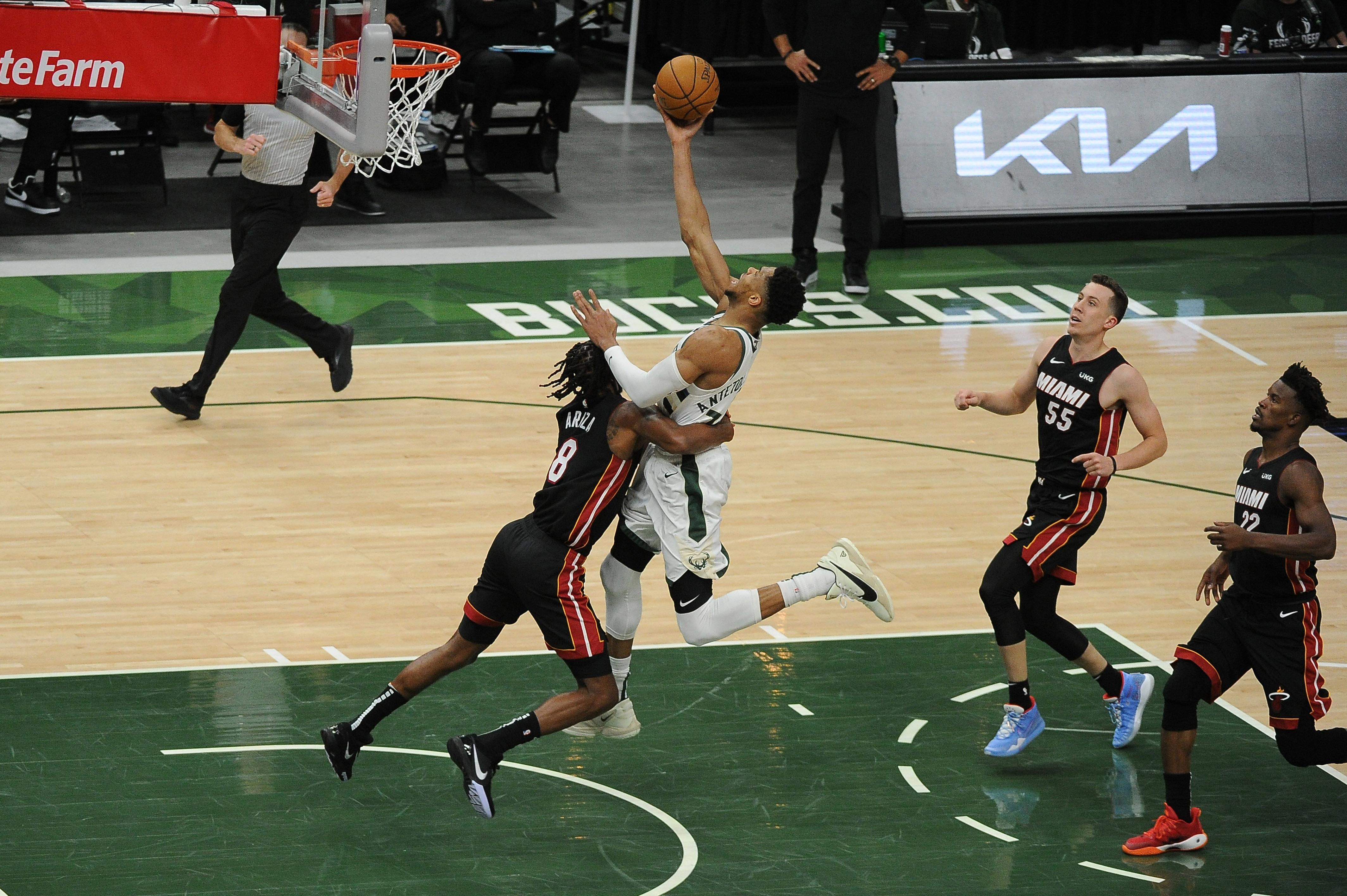 Milwaukee Bucks' Giannis Antetokounmpo fouls Miami Heat's Bam