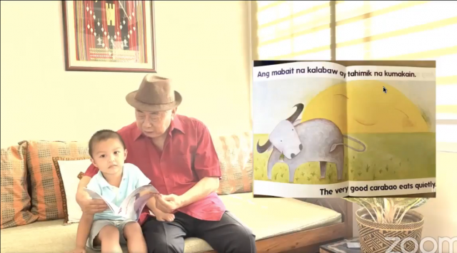 National Artist for Literature Virgilio S. Almario read his childrenâ€™s book Ang Mabait na Kalabaw to his youngest apo Agos. Photo: NBDB