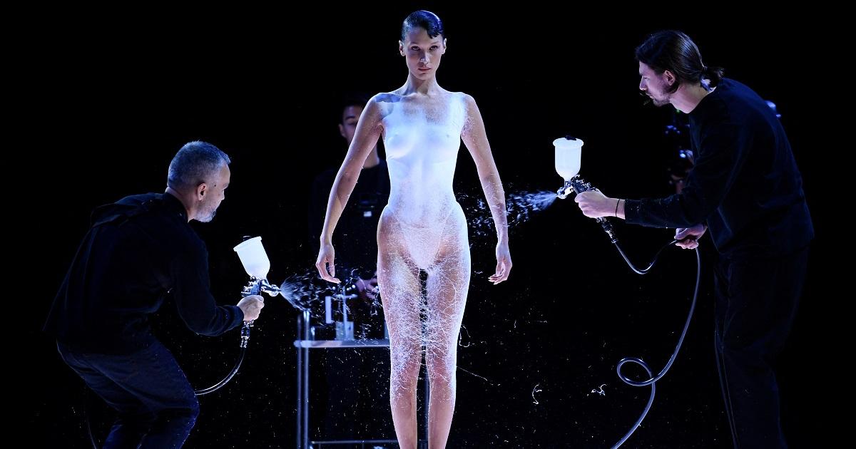 Bella Hadid Gets Dress Sprayed on Her Nude Body At Paris Fashion Week