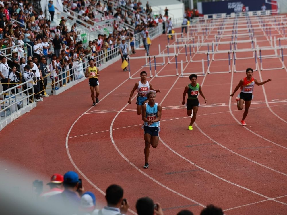 Mico, in his strikingly dyed hair, leads a pack of runners in the 110m hurdles | Courtesy: PSC Pool