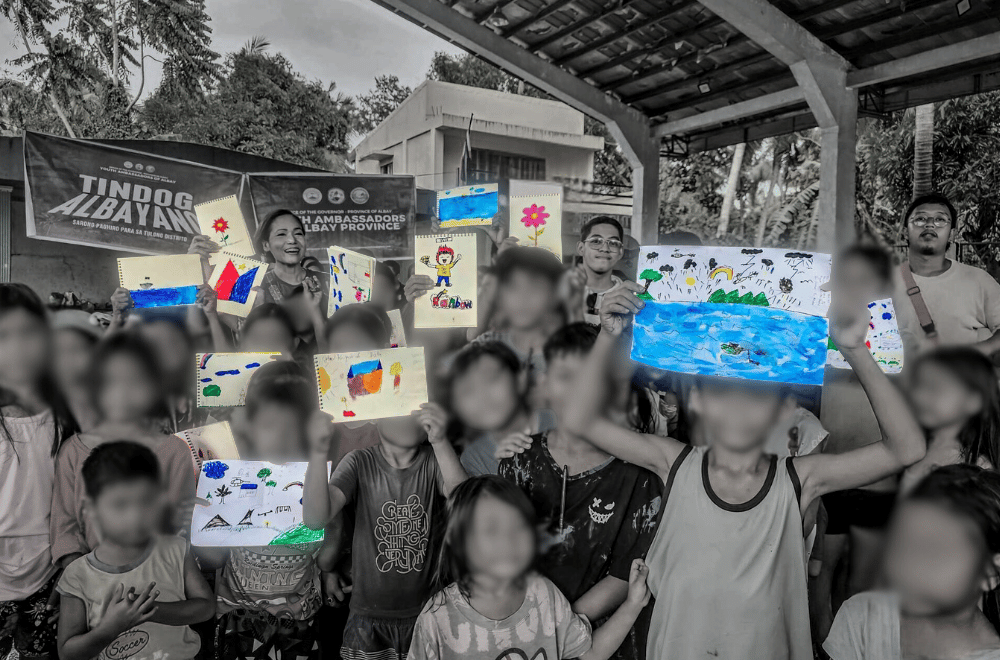 Kids hold up their drawings in an art intervention after STS #KristinePH | Photo courtesy: Dee Jai