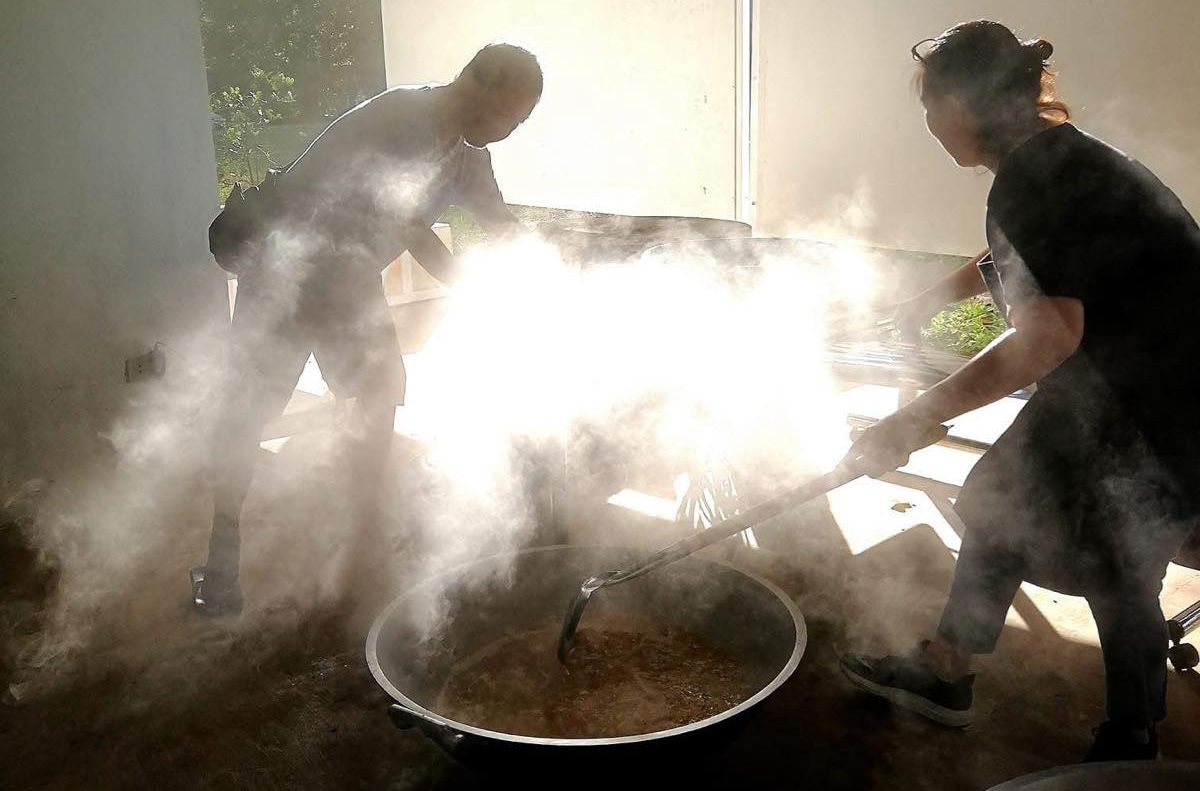 Alex Baluyut, left, with a volunteer at an ARM-K emergency kitchen | Photo by Little Wing Luna