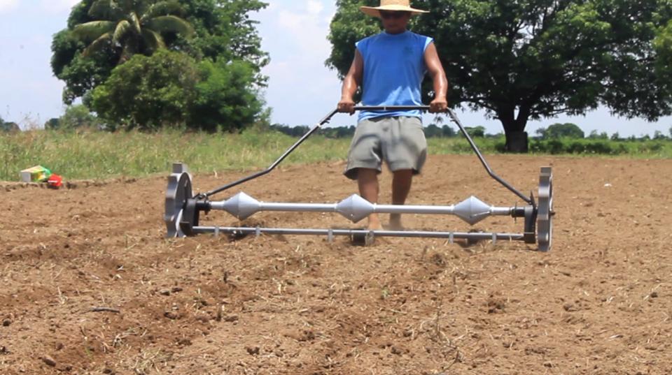 invented a device that speeds up the laborious process of corn planting. ag...