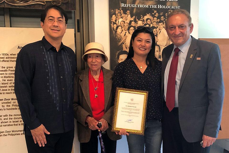Filipino caregiver Sharmaine Fernandez (2nd right) is flanked by Holocaust survivor Missa Schindler (2nd left), Philippine Ambassador to Israel Neal Imperial (left), and Dr. Abraham Schindler at the Philippine Embassy in Tel Aviv on April 17, 2019, after she was awarded a commendation for saving Schindler from being ran over by a vehicle. Fernandez shares her award with the Schindlers. PHL Embassy photo 
