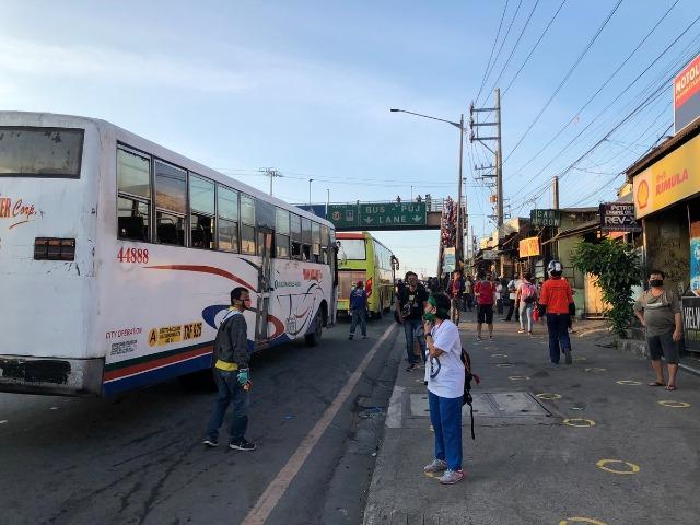 Commuters wait for buses on Commonwealth Avenue