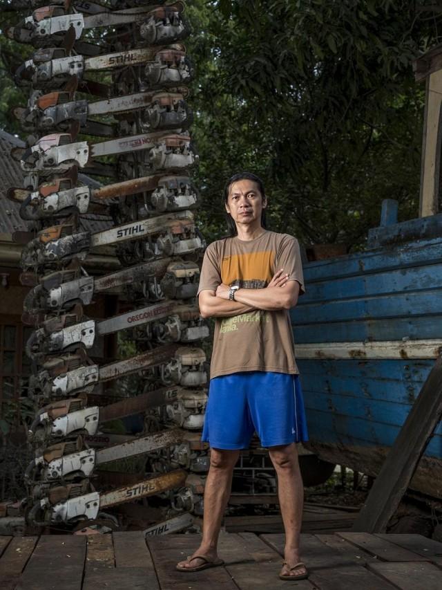 Bobby Chan stands in front of chainsaw at PNNI Headquarters. Photo: Thom Pierce