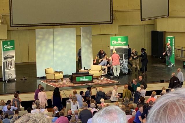 Author Salman Rushdie is helped by people after he was stabbed on stage before his scheduled speech at the Chautauqua Institution, Chautauqua, New York, US, August 12, 2022, in this picture obtained from social media. Charles Savenor/ LOCAL NEWS X/ TMX/ via REUTERS